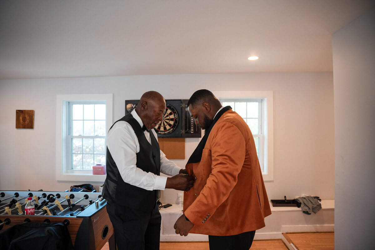Groom getting ready with his father before a Maryland wedding ceremony