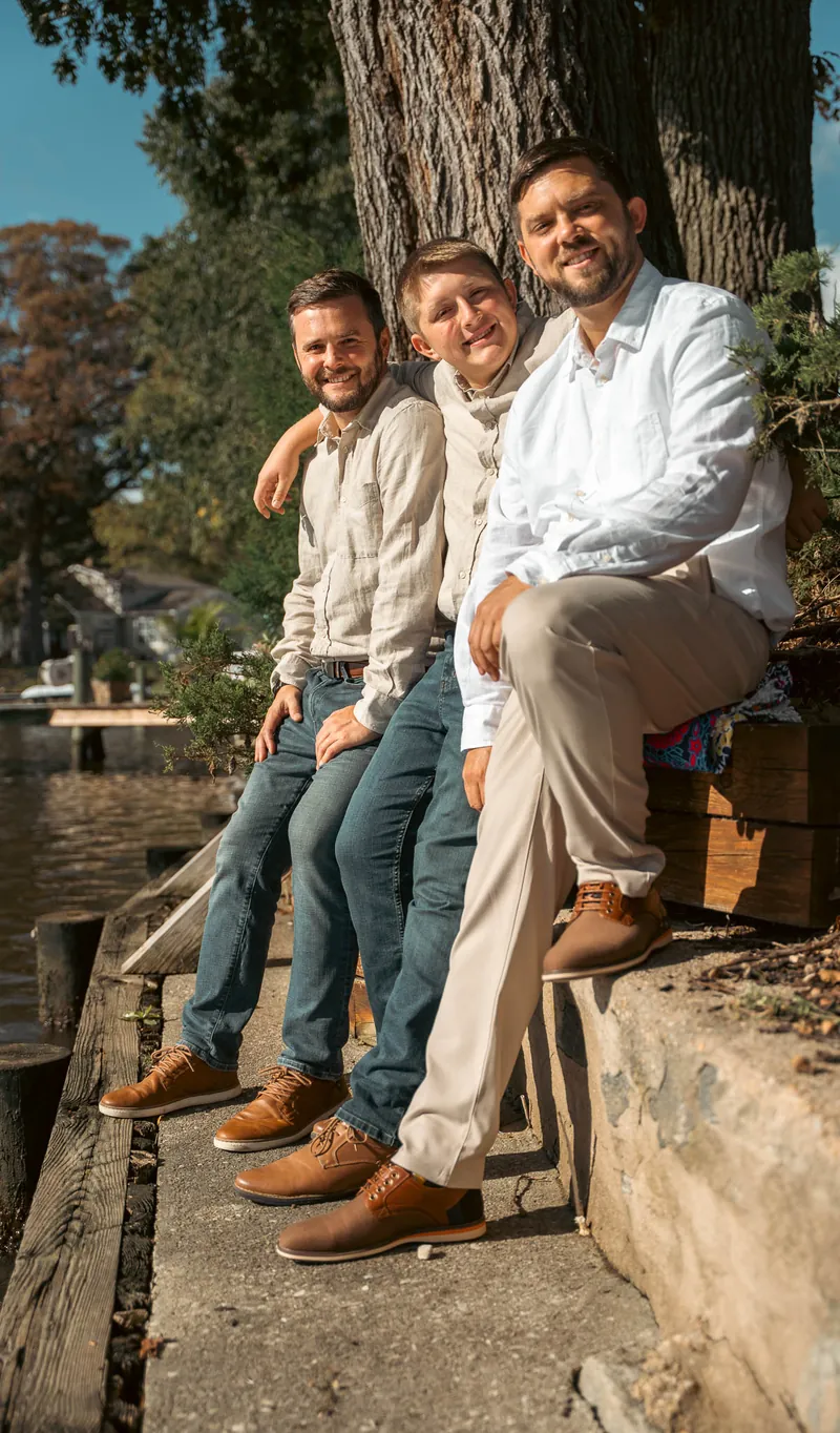 The groom and his sons on the stone steps by the water, morning light