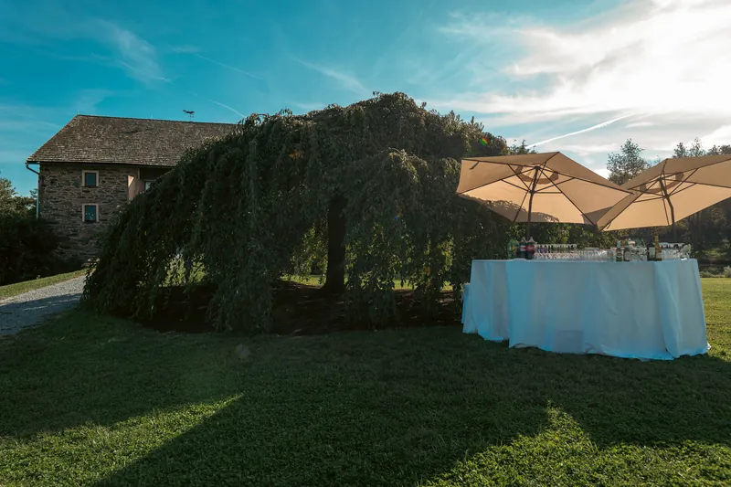 The stone manor and willow, tables set and waiting — Sylvanside Farm