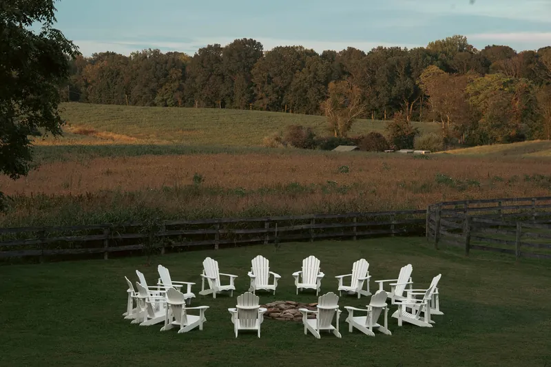 Adirondack chairs circled around the fire pit at dusk — Sylvanside Farm
